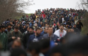 Migrants walk along a road as they look for a way to cross the Greek-Macedonian border, near the village of Idomeni, March 14, 2016. REUTERS/Stoyan Nenov