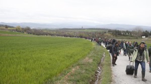 Migrants walk along a path looking for a way to cross the Greek-Macedonian border, near the village of Idomeni March 14, 2016. REUTERS/Stoyan Nenov