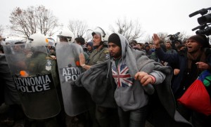 Migrants are stopped by Greek riot police as they look for a way to cross the Greek-Macedonian border, near the village of Idomeni, Greece, March 14, 2016. REUTERS/Stoyan Nenov